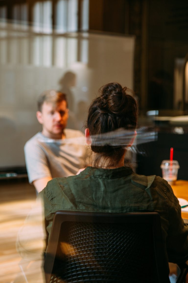 muslim women in tech giving and receiving feedback with joy. a picture of a woman and man sitting in a meeting