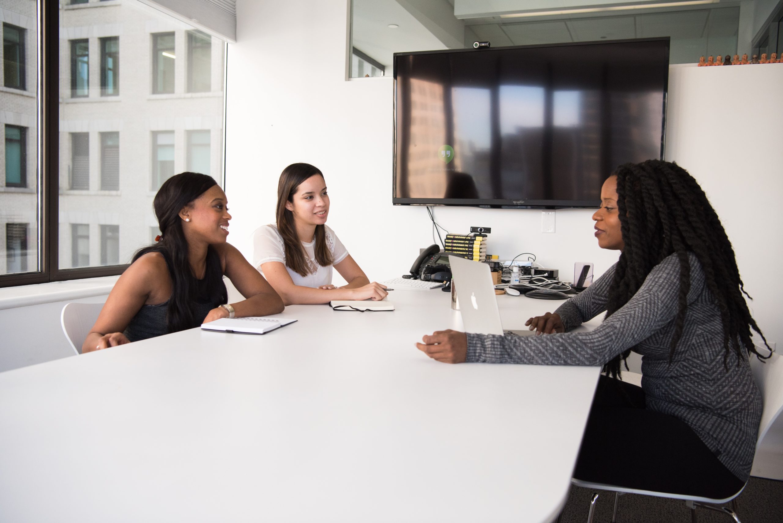 muslim women in tech career guide featured image. 3 women at a meeting around a table